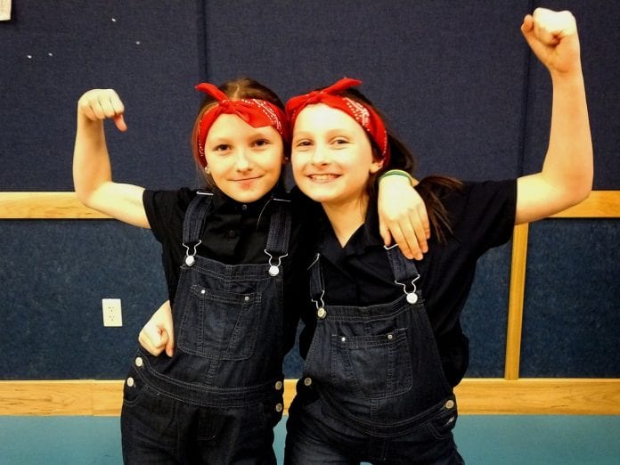 Third-grade Rosie the Riveter twins Isabella and Victoria Nothstine flex their muscles and smiles following the program’s conclusion. Photo by Nicole Nothstine/For The Cordova Times