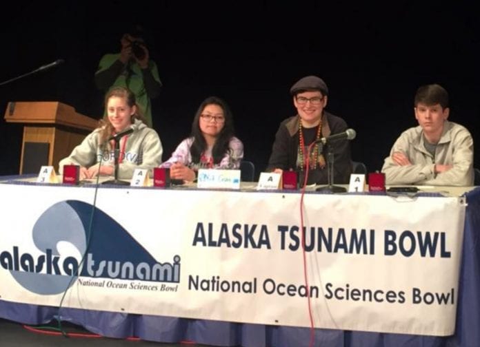 From left, MiKita DeCook, Marie Jamille Esguerra, Cori Pegau and Reid Williams, of the team ‘Yeti Crabs’, take the stage in front of 200 people before the final and championship round of the buzzer competition during the Alaska Tsunami National Ocean Sciences Bowl. Photo by Lauren Bien/for The Cordova Times