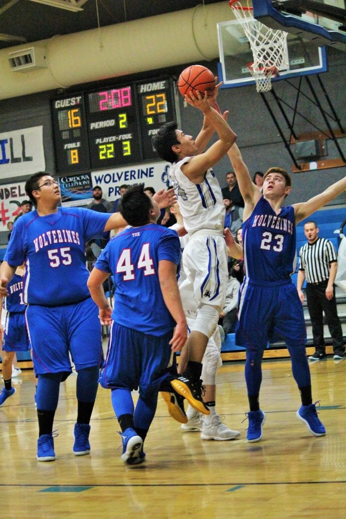 Cordova standout sophomore Christian Adams goes up for a rebound put-back against three flat-footed Tok defenders at CHS court on Feb. 16, 2018. Mikie McHone/for The Cordova Times