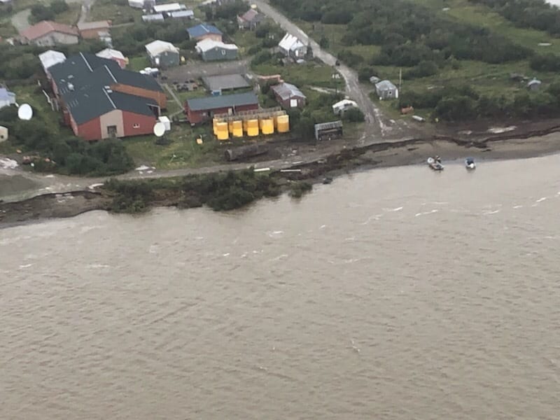The Napakiak School fuel storage facility sits 76 feet from the erosion point of the Lower Kuskokwin River on Aug. 16, 2019. The facility, owned by the Lower Kuskokwim School District, holds an estimated 36,000 gallons of home heating oil. The Coast Guard has ordered that fuel removed by Aug. 30. Photo courtesy U.S. Coast Guard