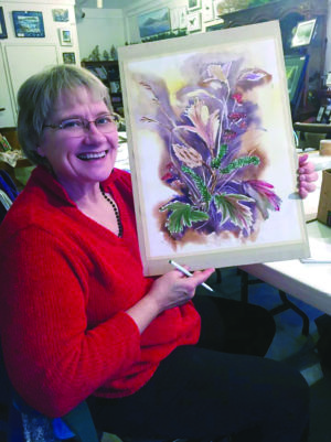Mazie VanDenBroek at Harbor Art gallery and communal art studio in 2015 with one of her watercolors in progress. Photo by Vivian Kennedy/For The Cordova Times