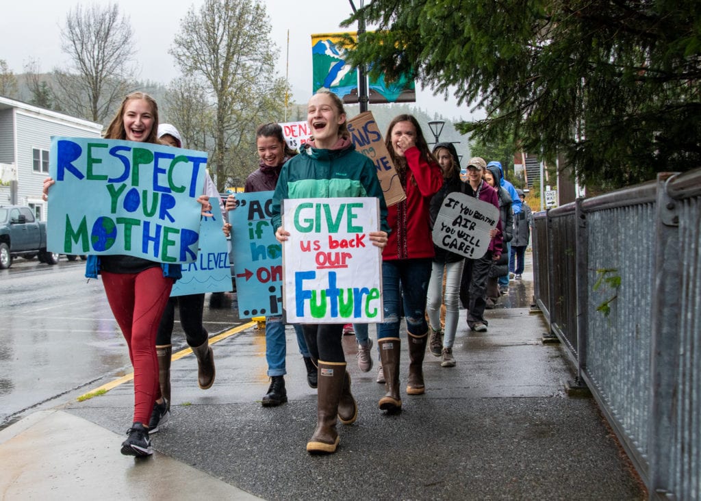 Front, from left: Maya Russin, 16, and Mia Siebenmorgen, 14, lead an anti-climate-change march down First Street. (Sept. 20, 2019) Photo by Zachary Snowdon Smith/The Cordova Times