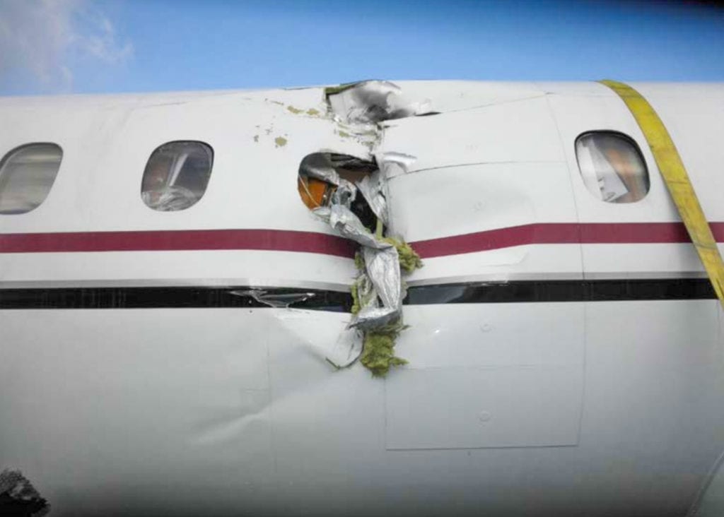 Damage to the left side of the fuselage of the Saab 2000 plane involved in an Oct. 17 accident that claimed one life. Photo courtesy of the National Transportation Safety Board