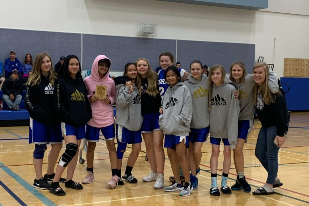 The Cordova Girls Junior High basketball team accepts their second-place trophy on Nov. 9 at the Valdez Junior High Tournament. From left, Faith Hatch, Jheryel Itliong, Yagnnesis Mejia, Ayessa Itliong, Alice Graves, Allison Ritter, Kate Flores, Anika Jensen, Elizabeth Heidbrink, Maggie Herschleb and Coach Heather Richardson. Photo courtesy of Heather Richardson/for The Cordova Times