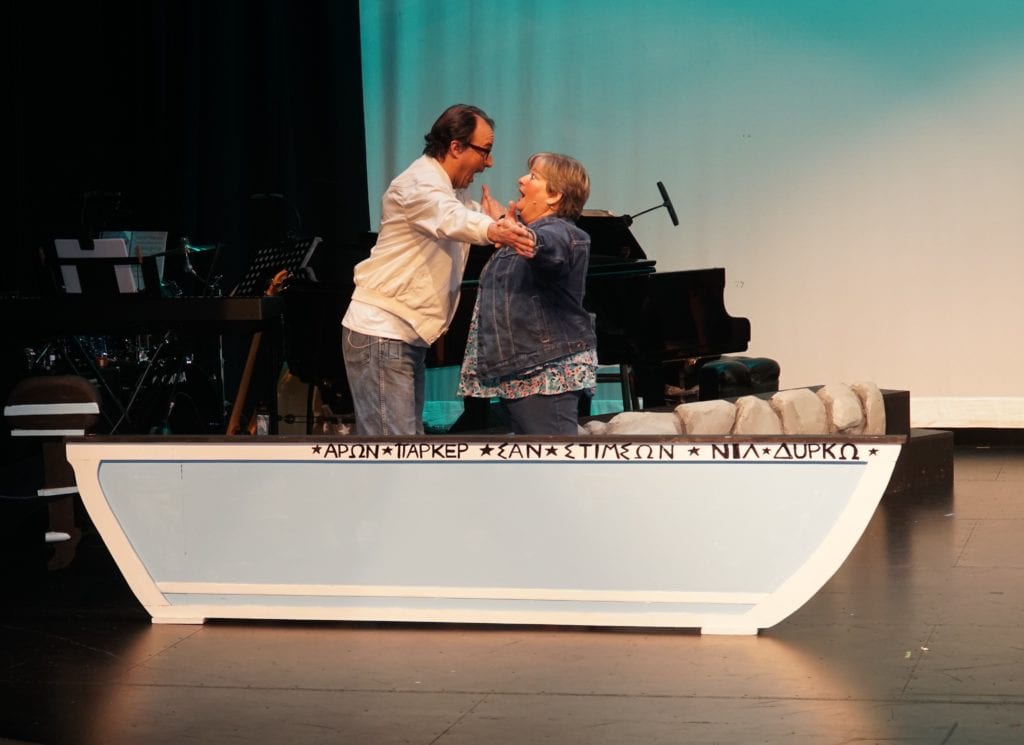 From left, “Mamma Mia!” cast members Joseph Fuentes and Gayle Groff. A boat prop was used to memorialize cast and crew members who died while “Mamma Mia!” was preparing for production. Photo courtesy of Barclay Kopchak